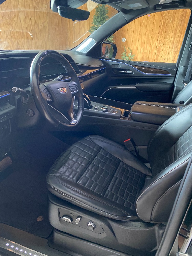 Luxurious Cadillac interior with clean black leather seats and wood trim