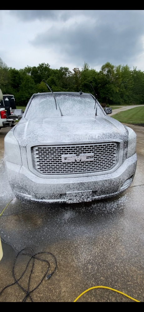 GMC truck with professional soap application during exterior detailing process